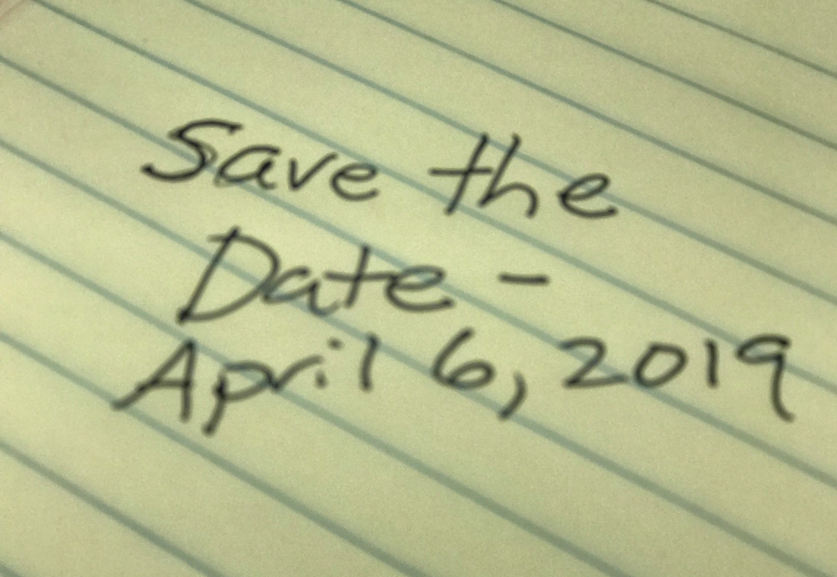 Save the Date - April 6, 2019 written on yellow legal pad in soft focus