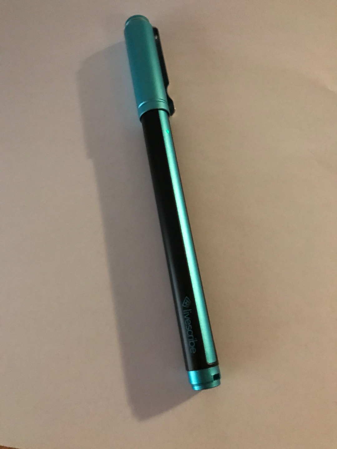 A picture of a Livescribe pen with too much shadow and not enough contrast.